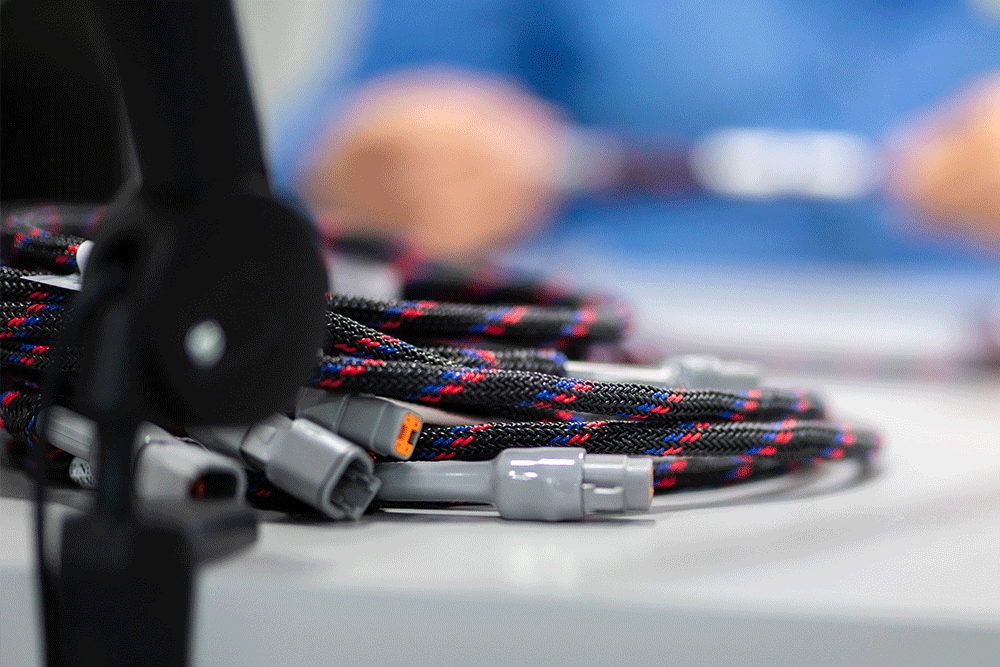 cable assembly assembler wire harnesses on a table. Cable manufacturer Precision Cables