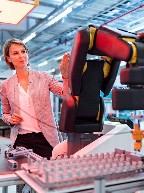 vertical image business women in front of robotic arm. precision cables website